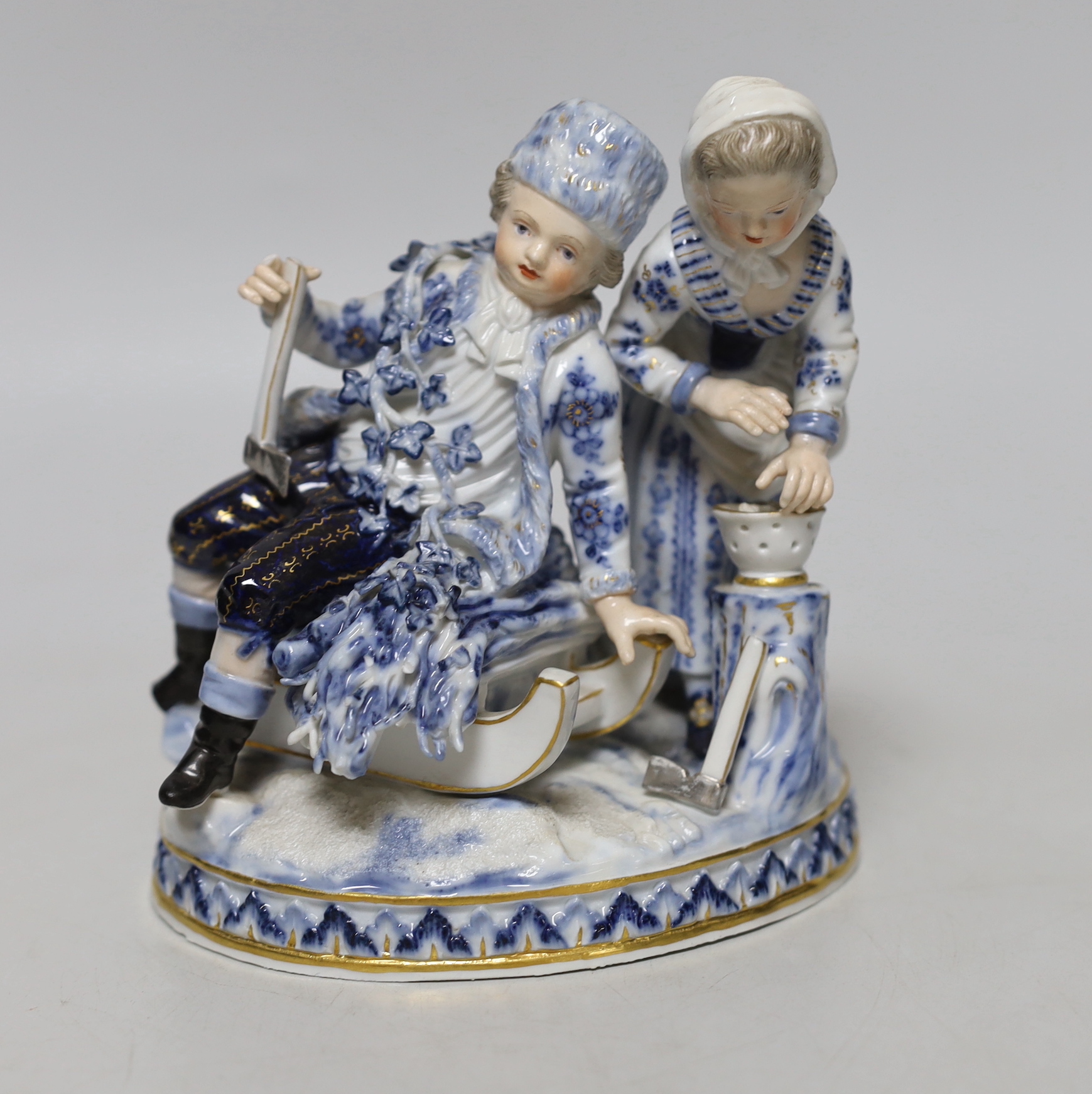 A Meissen blue and white figural group, 15cm high